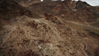 DCA04_073 - Aerial stock footage of 4K aerial  video of flying over and tilting to rocky slope of Hiller Mountains, Nevada