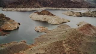 DCA04_084 - 4K aerial stock footage of flying over shore of Lake Mead toward small islands, Nevada
