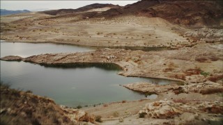 DCA04_086 - 4K aerial stock footage of flying over ridge on shore of Lake Mead, Nevada