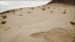 DCA04_089 - 4K aerial stock footage of flying over sandy dunes near Lake Mead, Nevada