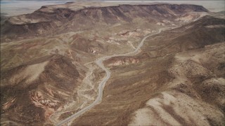 DCA04_095 - 4K stock footage aerial video of following a winding road in the Nevada Desert, Nevada