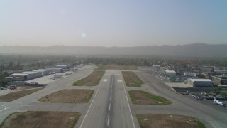 DCA05_002 - 4K stock footage aerial video of lifting off from Van Nuys Airport runway, Van Nuys, California