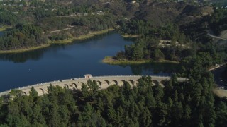 DCA05_020 - 4K aerial stock footage of flying over Mulholland Dam, Hollywood Reservoir, Los Angeles, California