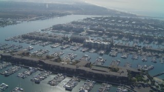 DCA05_064 - 4K aerial stock footage of flying over the marina, tilt down on boats, Marina Del Rey, California