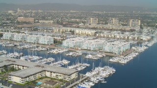 DCA05_069 - 4K aerial stock footage pan to boats in the marina and waterfront apartments, Marina Del Rey, California