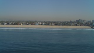 DCA05_075 - 4K aerial stock footage of the beach seen from ocean, reveal Venice Fishing Pier, Venice, California