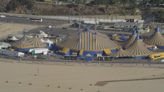 DCA05_081 - 4K aerial stock footage approach Santa Monica Pier, circus tents on beach, Santa Monica, California