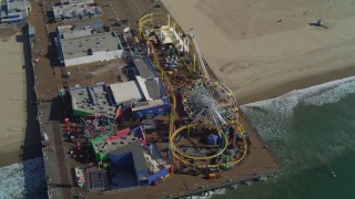 DCA05_082 - 4K aerial stock footage tilt to bird's eye view of Santa Monica Pier rides, Santa Monica, California