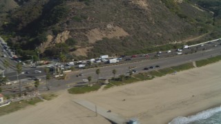 DCA05_097 - 4K aerial stock footage of flying by Highway 1 near the coast, Pacific Palisades, California