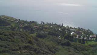 DCA05_110 - 4K aerial stock footage of hiking trail on hill, homes on cliff overlooking the Pacific Ocean, Malibu, California