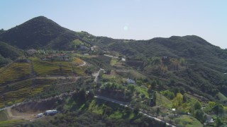 DCA05_136 - 4K aerial stock footage of flying by homes and vineyards in the hills, Malibu, California