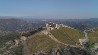 DCA05_139 - 4K aerial stock footage of orbiting a winery and vineyard on a hill, Malibu, California