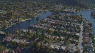 DCA05_144 - 4K aerial stock footage pan across homes, Westlake Lake, reveal mountains, Westlake Village, California