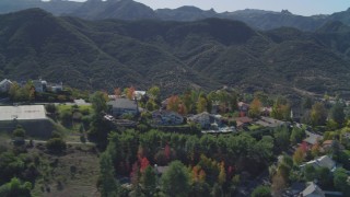 DCA05_147 - 4K aerial stock footage of flying by upscale homes on a hill, revealing a mansion, Westlake Village, California