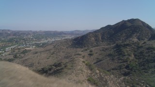 DCA05_148 - 4K aerial stock footage of flying over a hill, revealing Agoura Hills, California
