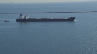 DCA06_026 - 4K aerial stock footage of flying away from oil tanker near breakwater, Long Beach, California