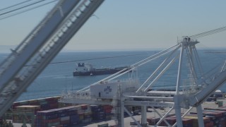 DCA06_030 - 4K stock footage aerial video of an oil tanker seen from cargo cranes at Port of Long Beach, California