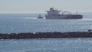 DCA06_035 - 4K aerial stock footage of an oil tanker and tugboat near breakwater, Long Beach, California