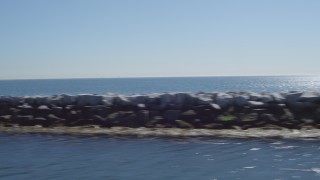 DCA06_037 - 4K aerial stock footage fly away from an oil tanker, pan across breakwater, Long Beach, California