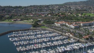 DCA06_046 - 4K aerial stock footage of flying by a hotel and a marina full of boats in San Pedro, California