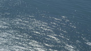 DCA06_060 - 4K aerial stock footage of a reverse view of light shimmering on the ocean, Southern California