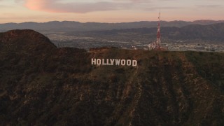 DCA07_002 - 4K stock footage aerial video of flying by the Hollywood Sign, Los Angeles, California, sunset