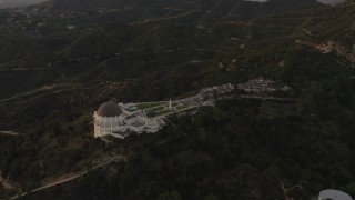 DCA07_004 - 4K aerial stock footage of orbiting around the south side of the Griffith Observatory, Los Angeles, California, sunset