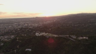 DCA07_005 - 4K aerial stock footage of orbiting the east side of the Griffith Observatory, Los Angeles, California, sunset