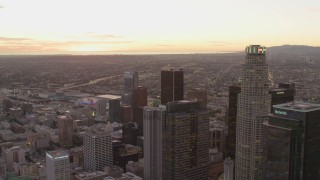 DCA07_008 - 4K aerial stock footage of flying by Downtown Los Angeles skyscrapers, California, sunset