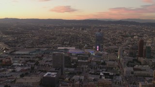 DCA07_009 - 4K stock footage aerial video of flying by Staples Center, The Ritz-Carlton, Downtown buildings, Los Angeles, California, sunset