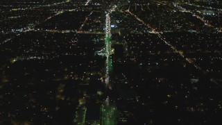 DCA07_073 - 4K aerial stock footage of following Wilshire Blvd, reveal Century City, Mid-Wilshire, Los Angeles, California, night
