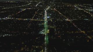 DCA07_074 - 4K aerial stock footage of following Wilshire Blvd toward Century City, tilt down, Mid-Wilshire, Los Angeles, California, night