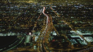 DCA07_111 - 4K aerial stock footage of following Interstate 10 through Downtown Los Angeles, California, night