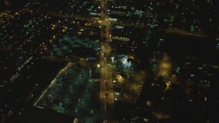 DCA07_116 - 4K aerial stock footage of flying over Atlantic Avenue, Bell, California, night