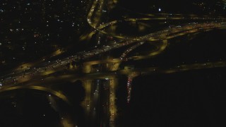DCA07_121 - 4K aerial stock footage of flying away from Highway 91 and Interstate 710 interchange, Long Beach, California, night