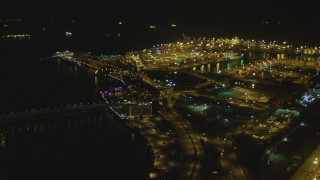 DCA07_124 - 4K stock footage aerial video fly over the Port of Long Beach, approaching RMS Queen Mary, Long Beach, California, night