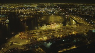 DCA07_131 - 4K stock footage aerial video of cargo containers, cranes, Port of Long Beach, California, night