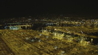DCA07_151 - 4K aerial stock footage pan across cargo containers and cranes, Port of Los Angeles, San Pedro, California, night
