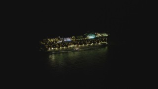 DCA07_154 - 4K aerial stock footage of orbiting a cruise ship sailing near the Port of Los Angeles, San Pedro, California, night