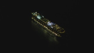 DCA07_155 - 4K aerial stock footage of a cruise ship sailing near the Port of Los Angeles, San Pedro, California, night