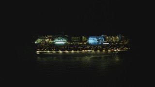 DCA07_156 - 4K aerial stock footage of a cruise ship sailing near the Port of Los Angeles, San Pedro, California, night