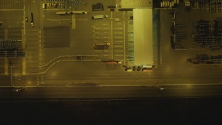 DCA07_159 - 4K aerial stock footage bird's eye view flying over trucks, cargo containers, Port of Los Angeles, San Pedro, California, night