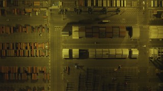 DCA07_161 - 4K aerial stock footage of bird's eye view of shipping containers, trucks, Port of Los Angeles, San Pedro, California, night