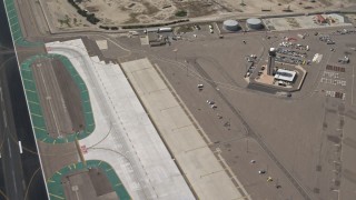 DCA08_010 - 4K aerial stock footage of panning across hangars and runway at San Diego International Airport, California