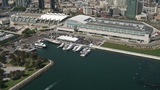 DCA08_015 - 4K aerial stock footage of yachts by the convention center in Downtown San Diego, California
