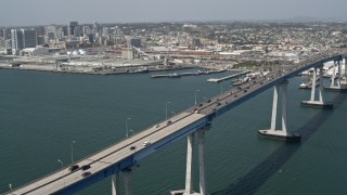 DCA08_021E - 4K stock footage aerial video orbit Coronado Bridge and reveal the skyline of Downtown San Diego, California