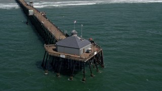 DCA08_033 - 4K aerial stock footage approach and orbit a pier in Imperial Beach, California