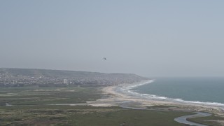 DCA08_034 - 4K aerial stock footage of tracking a military helicopter over Imperial Beach, California
