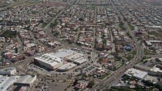 DCA08_042 - 4K aerial stock footage of a shopping center and urban neighborhood, Tijuana, Mexico