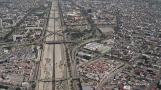 DCA08_049E - 4K aerial stock footage pan from Tijuana to reveal and orbit heavy traffic on the US/Mexico Border, Tijuana